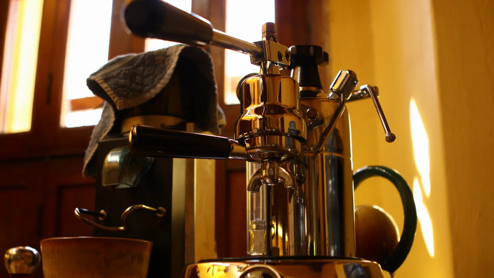 Espresso machine, burr grinder and kitchen scale on a home counter, typical affiliate review products