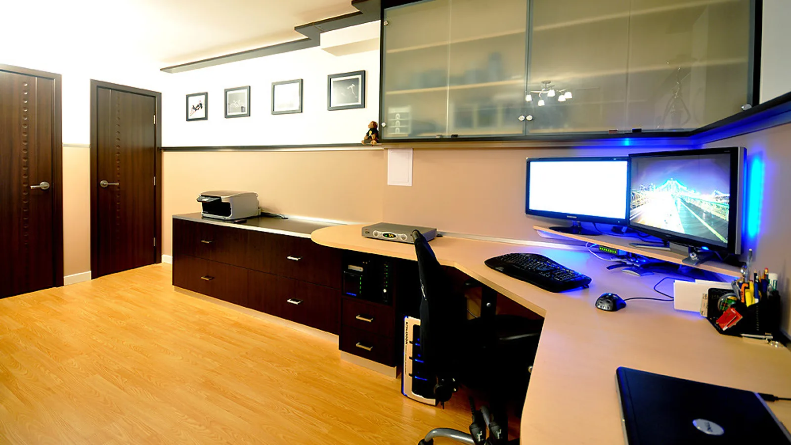 Office monitor, desk chair and printer in a small workspace