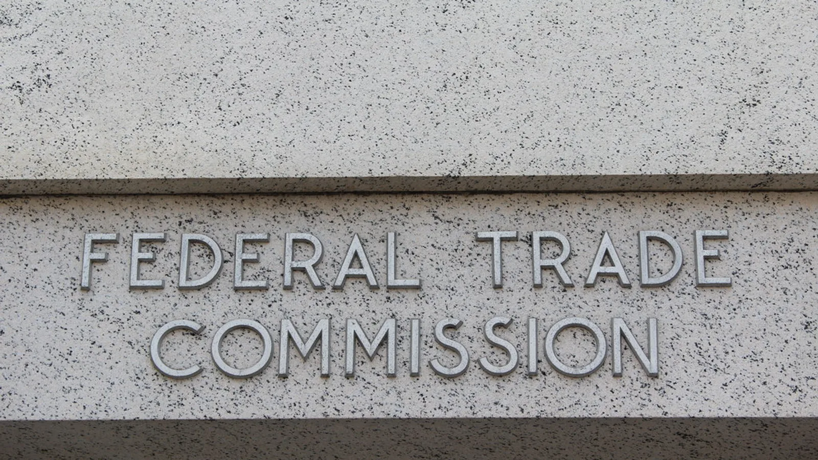 Federal Trade Commission seal and name plaque on the agency's building.